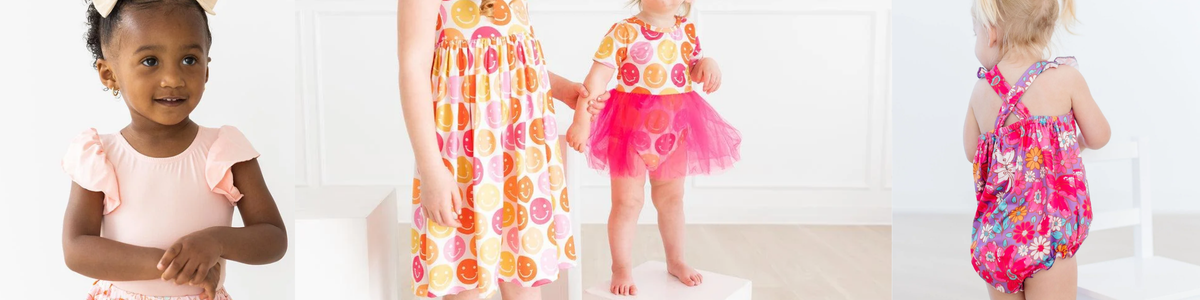 Toddlers wearing colorful smiley face dresses and floral rompers during a $10 sale event.