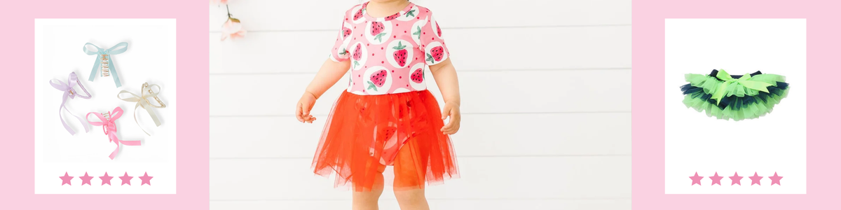 Toddler wearing a strawberry print bodysuit and red tulle tutu, flanked by colorful hair bows and a green ruffled skirt.