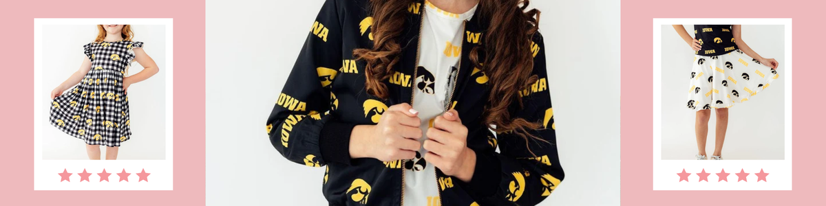 Young girl wearing a black and gold University of Iowa Hawkeyes zip-up jacket and matching branded apparel.
