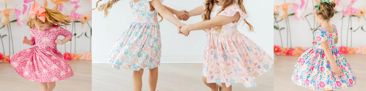 Girls in colorful, patterned twirl dresses with flutter sleeves spinning and holding hands in a bright studio.