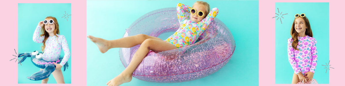 Girls wearing colorful long-sleeve swimsuits with playful patterns and fun sunglasses, posing with glittery pool floats.