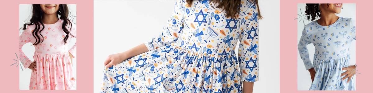 Light blue girls' Hanukkah dress featuring a festive menorah, dreidel, and Star of David print with a gathered skirt.