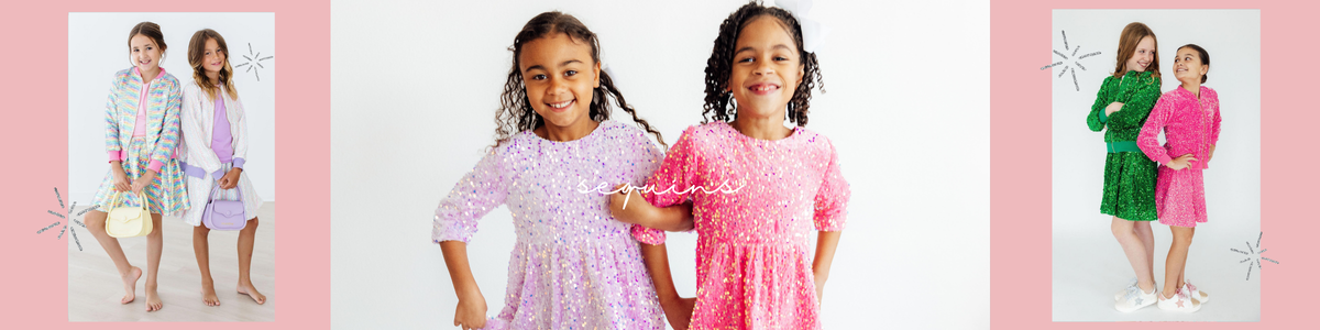 Two girls wearing vibrant green and hot pink sequin bomber jackets with matching skirts against a white background.