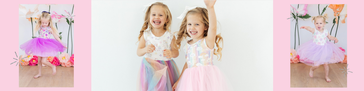 Happy young girls wearing colorful tank tutu dresses with rainbow and unicorn patterns and layered tulle skirts.
