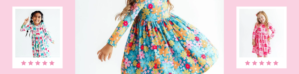Girls wearing colorful long sleeve twirl dresses with floral and patterned prints in a playful studio setting.