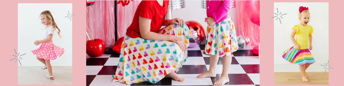 Mother and daughter wearing matching colorful heart-print twirl skorts in a fun, retro-themed party setting.