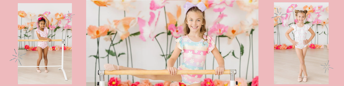 Young girls wearing floral flutter-sleeve leotards posing at a ballet barre in a whimsical, flower-filled studio.