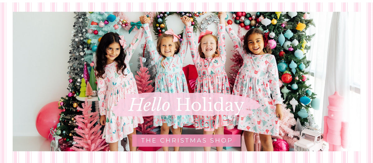 Girls wearing Mila & Rose Christmas dresses in festive pink and mint prints. Shop the Holiday Shop.